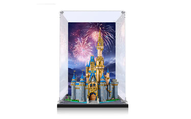 LEGO Disney Castle model displayed in clear acrylic case with fireworks background