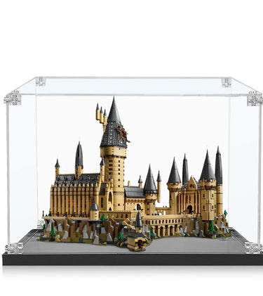 LEGO Hogwarts Castle model displayed in clear protective case with detailed turrets and rocky base