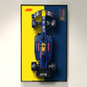 Top view of a LEGO Formula 1 race car model mounted on a split yellow and dark blue background