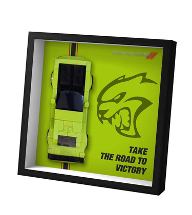 Framed lime green sports car model with aggressive panther logo and text 'Take the road to victory'