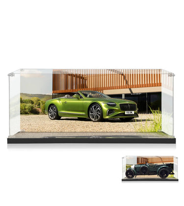 Green Bentley convertible model car displayed in clear acrylic display case with scenic background