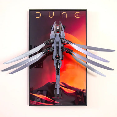 3D LEGO model of a sandworm with extended fins mounted on a Dune-themed desert sunset poster
