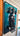 Framed black Mercedes AMG Petronas F1 car model mounted on a teal background inside a room
