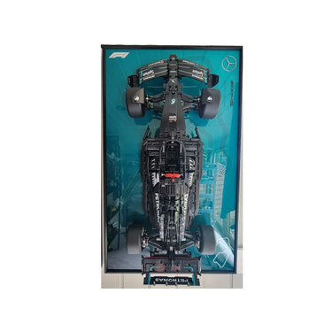 Top view of a detailed LEGO Mercedes AMG Petronas Formula 1 car model displayed on a teal background