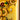 Close-up of illuminated yellow LEGO sunflowers with green leaves on a tiled yellow background
