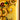 Close-up of illuminated yellow LEGO sunflowers with green leaves on a tiled yellow background