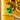 Close-up of a green LEGO scorpion with glowing eyes on a yellow LEGO baseplate with detailed brick patterns