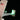 Close-up of LEGO spaceship tail fin with American flag and glowing green lights on black background