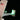 Close-up of LEGO spaceship tail fin with American flag and glowing green lights on black background
