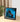 Framed display of blue LEGO Lamborghini Sian model on table with blurred background