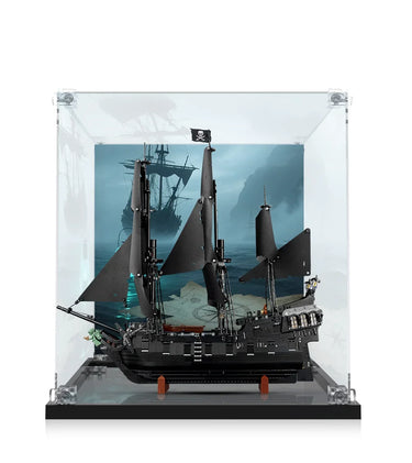 Black pirate ship model with sails and Jolly Roger flag in clear display case with ocean background