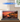 Medieval seaside market LEGO 910047 display case with sunset harbor and boats scene