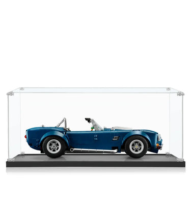 Blue classic convertible sports car model displayed inside clear glass showcase