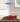 Red LEGO Ferrari FXX K model displayed in a clear acrylic display case on wood surface