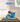 LEGO model of blue and white Nike Dunk sneaker with basketball and DUNK letters in clear display case