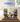 Lego Ninjago City Markets set 71799 displayed in clear protective case on wooden table with mini-figures and detailed building features