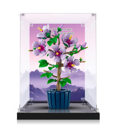LEGO model of a purple flower plant in a blue pot displayed in a transparent protective case with mountain backdrop