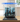 Black LEGO pirate ship model for set 10365 displayed in clear acrylic case on wooden table