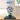 LEGO hibiscus flower model 10372 in blue pot displayed inside glass case on wooden surface