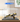 Lego bush plane model 42198 displayed in clear acrylic case on wooden table