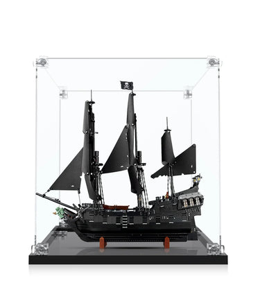 Black LEGO pirate ship model with tattered sails and Jolly Roger flag in clear display case