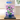 LEGO hibiscus flower model in blue pot displayed in clear protective case on wooden table