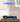Lego Shelby Cobra 427 S/C model car in blue displayed in clear acrylic case on wooden table