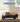 LEGO Bentley Blower model 13191 displayed in a clear acrylic case on a wooden table
