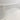 Clear acrylic shield divider on white desk against light gray wall for office or workspace safety