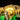 Close-up of illuminated beige LEGO dinosaur skeleton model with green and yellow LED lights