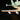 Close-up of a LEGO NASA space shuttle wing with LED lights and detailed engines on black background