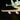 Close-up of a LEGO NASA space shuttle wing with LED lights and detailed engines on black background