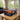 McLaren Technic model of an orange and blue Formula 1 car in a clear display case on a wooden table