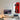 Minimalist workspace with desktop computer, wooden desk, and framed red Formula 1 car art on wall