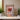 Framed Dungeons & Dragons LEGO minifigures display with red dragon centerpiece on white shelf
