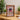 Wooden display case featuring Dungeons & Dragons 5e collectible mini-figures with fantasy artwork backdrop