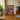 Framed Daily Bugle LEGO Spider-Man minifigures display on wooden desk in cozy room with plants and books