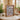 Wood-framed Harry Potter Daily Prophet LEGO minifigures display on a table with plants and books in background