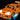 Orange LEGO sports car model with headlights, roof lights, decals, and underglow lighting on black background