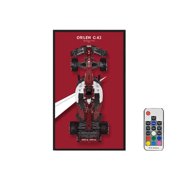 Top-down view of Alfa Romeo ORLEN C42 Formula 1 car LED wall art with remote control on red background