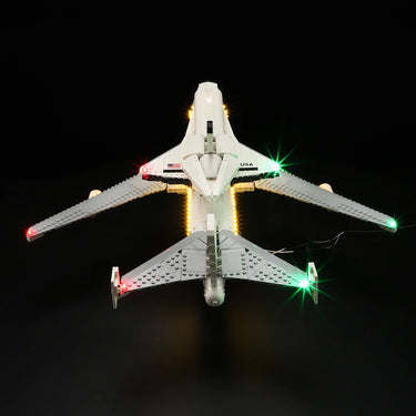 LEGO model of NASA space shuttle with LED lights on white wings and black background