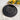Round black wall clock with white numbers on two circles and gold clock hands on a cream cloth