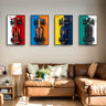 Four framed prints of Formula 1 cars in red, orange, blue, and black colors displayed above a brown leather sofa in a living room