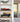 Shelf with red Formula 1 car model and vintage green car model in clear display cases in bright modern room