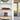 Modern shelves with a LEGO red race car and a LEGO Gotham Arkham building display in clear cases near a glass door