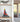 Modern interior with model sailboat in glass display on wooden shelf and wine glasses on table
