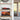 Modern living room shelves with red Formula 1 car model and sunset harbor photo inside glass cases