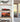 Modern living room shelves with red Formula 1 car model and sunset harbor photo inside glass cases