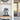 Blue and gray robot figure in clear display case on wooden shelf in modern room with glass door