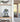 Blue and gray robot figure in clear display case on wooden shelf in modern room with glass door
